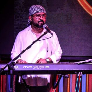 Keyboard Teacher Playing Keyboard at concert